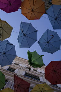 Low angle view of umbrellas against sky