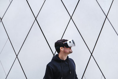 Portrait of man photographing against sky