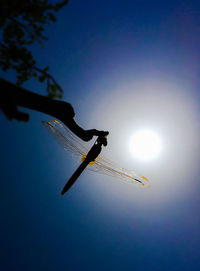 Low angle view of crane against clear blue sky