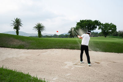 Rear view of man on golf course