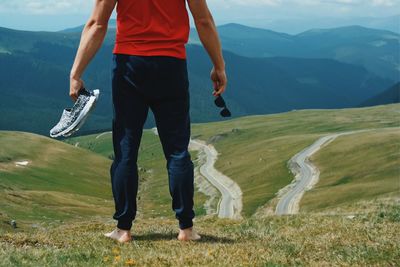 Low section of man walking on mountain