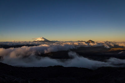 Scenic view of volcanic mountain against sky during sunset