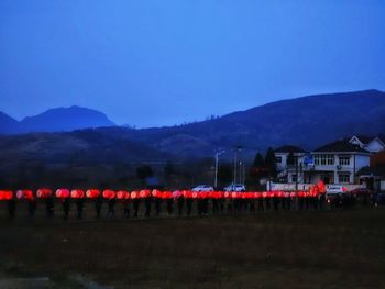 Illuminated mountains against blue sky