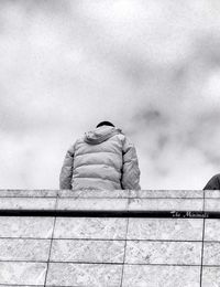 Silhouette of woman against cloudy sky