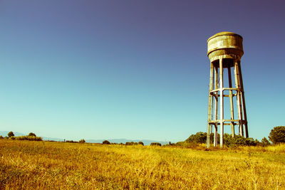 Low angle view of agricultural field against clear sky