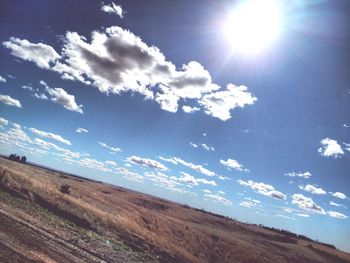 Scenic view of landscape against sky on sunny day