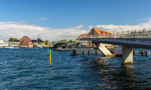 View of bridge over river against cloudy sky