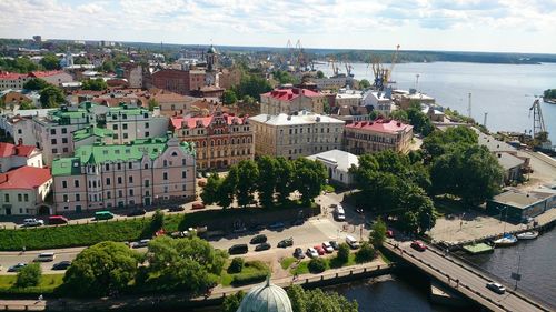 High angle view of town by sea against sky