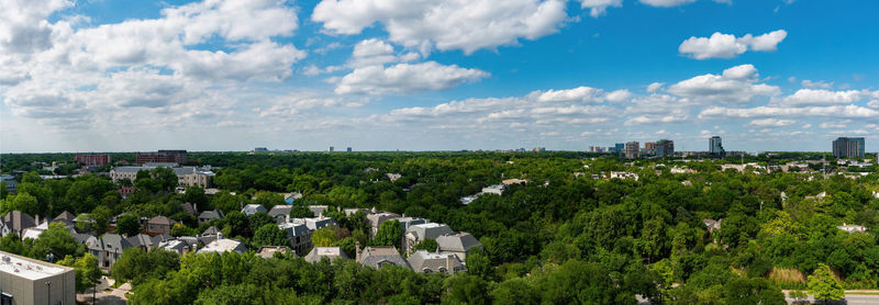 Panoramic view of trees and buildings against sky