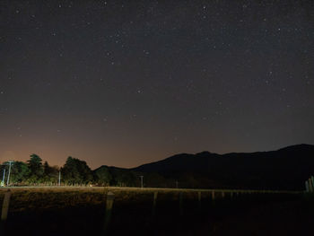 Scenic view of mountains against sky at night