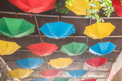 High angle view of multi colored umbrellas hanging at market stall