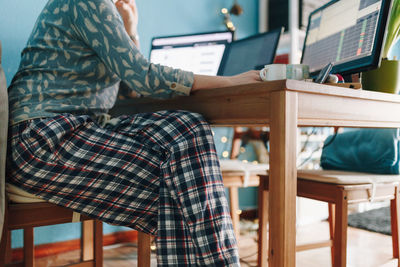 Midsection of woman working at home