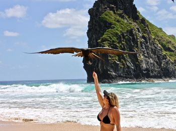 Rear view of woman walking on beach