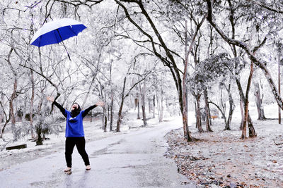 Full length of man walking on snow covered road