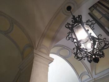 Low angle view of illuminated chandelier hanging in building
