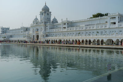 People at temple against clear sky