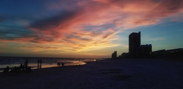 Scenic view of beach against sky during sunset