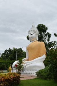 Statue of buddha against sky