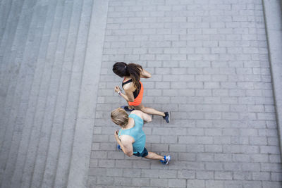 High angle view of joggers running towards steps