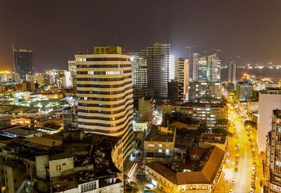 High angle view of illuminated cityscape against sky at night