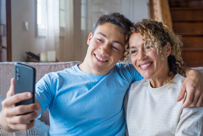 Portrait of smiling woman using mobile phone