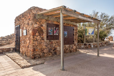 Exterior of abandoned building against clear sky
