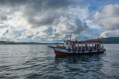 Boat sailing on sea against sky