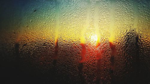 Full frame shot of raindrops on glass window