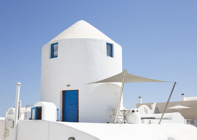 Low angle view of house against clear blue sky