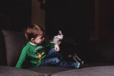 Boy sitting on sofa at home