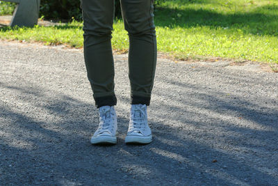 Low section of man standing on grass