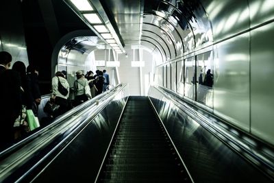 People on escalator at subway station