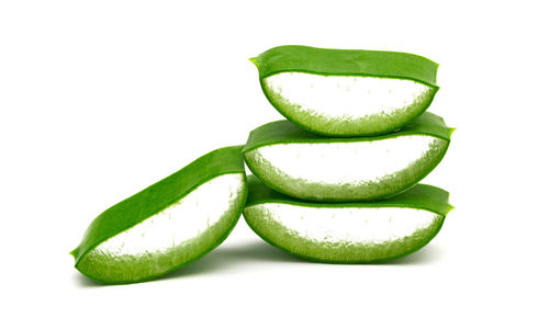 Close-up of green fruit against white background