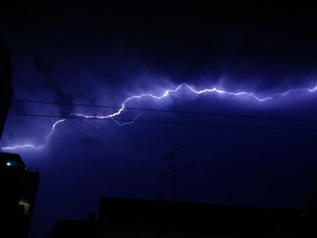 Low angle view of lightning against cloudy sky