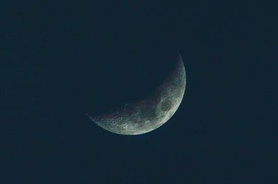 Low angle view of half moon against sky at night