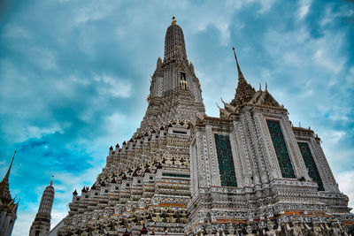 Low angle view of temple building against cloudy sky