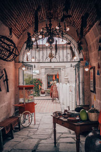 Table and chairs on floor against building