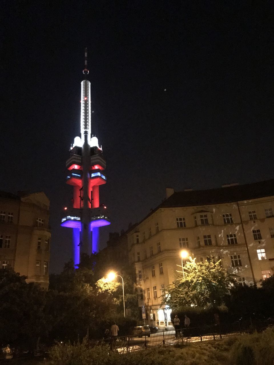 LOW ANGLE VIEW OF ILLUMINATED BUILDING AT NIGHT