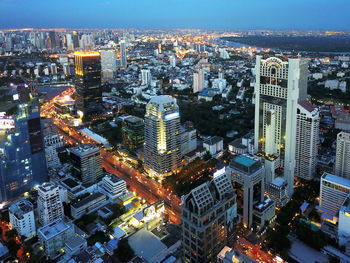 High angle view of city lit up at night