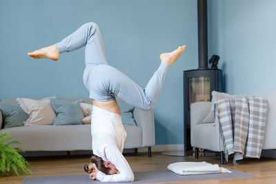 Young woman doing yoga at home