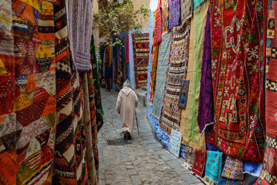 Rear view of people walking on street