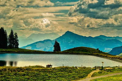Scenic view of field and mountains against sky