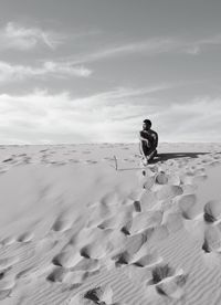 Man on sand against sky
