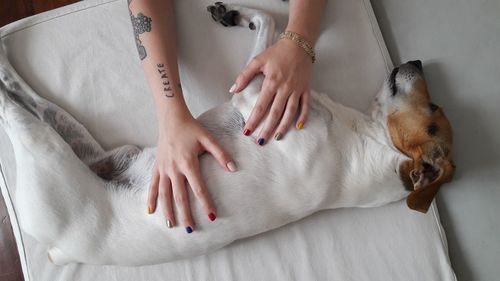 Midsection of woman resting on bed