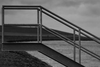 Metal bridge against sky