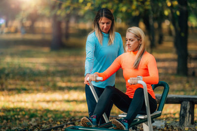 Women exercising outdoors in a public park.