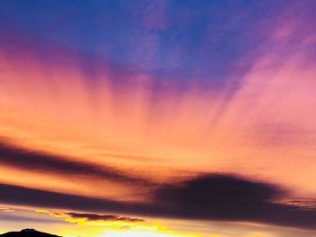 Low angle view of dramatic sky during sunset