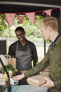 Clients buying food at food stall