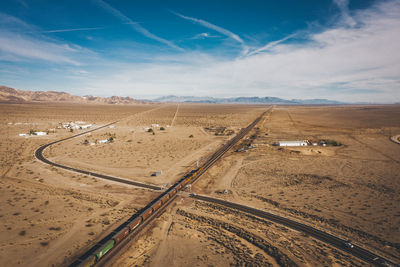 Scenic view of desert road against sky