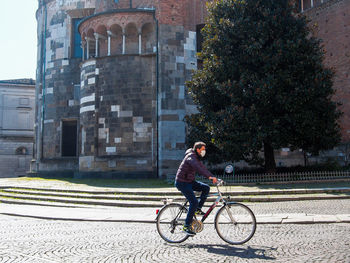 Man riding bicycle on street in city